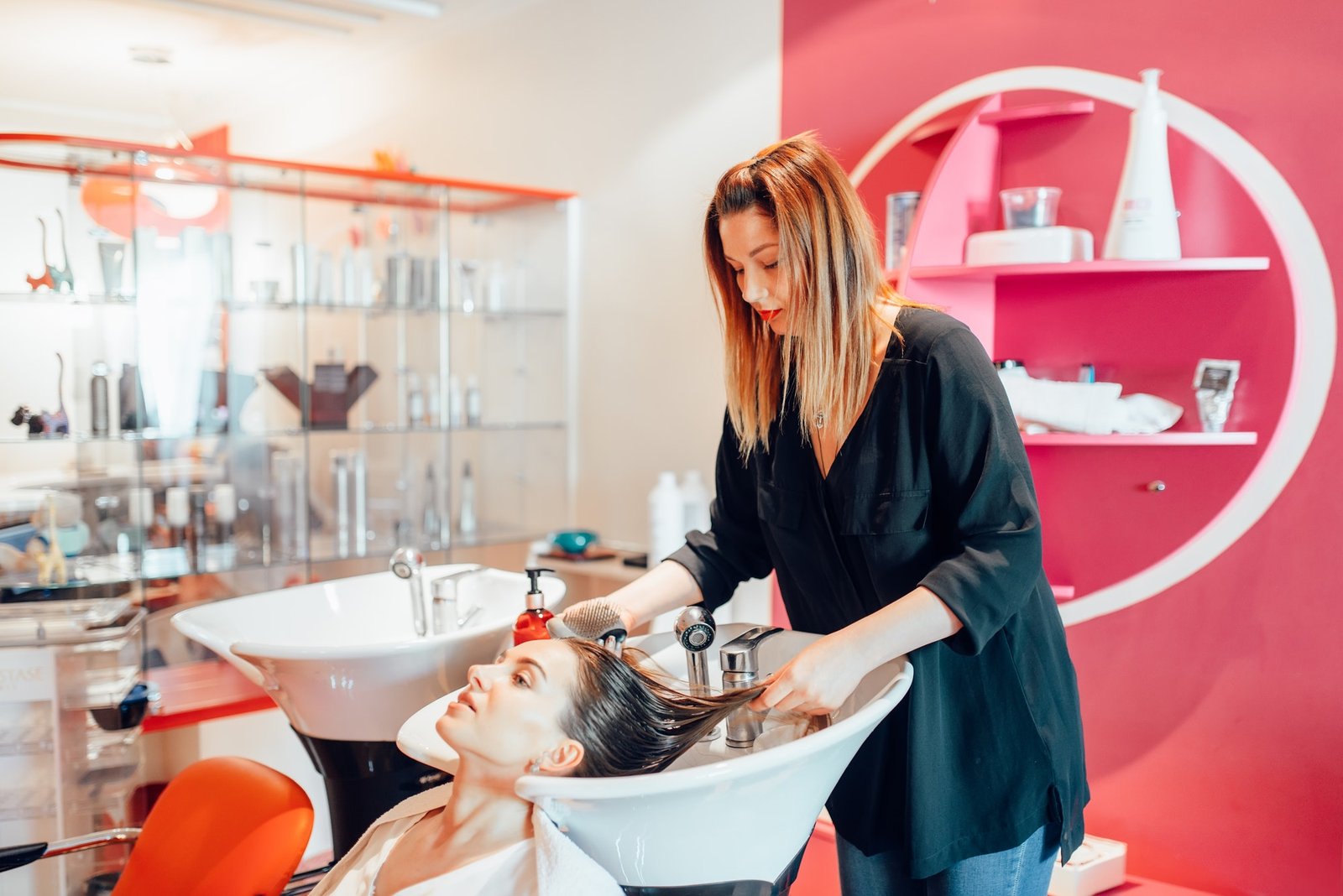 Hairdresser washes hair in hairdressing salon